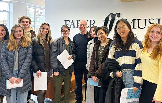 Whitman students posing with Toby Faber in front of Faber Music logo