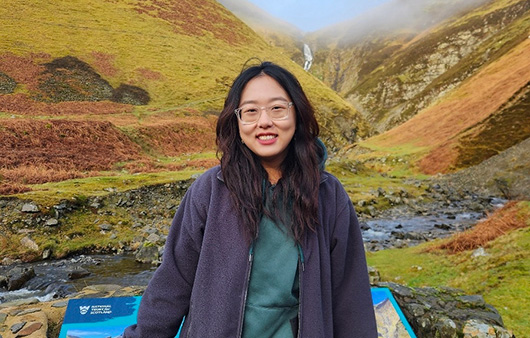 Annie Xu with Scottish landscape in the background