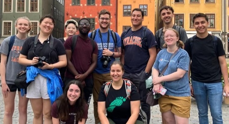 Syracuse students in front of a building